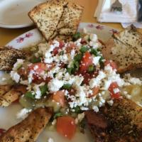 Melanzana · Charbroiled eggplant, feta cheese, tomatoes, scallions and herbs. Served with toasted pita.