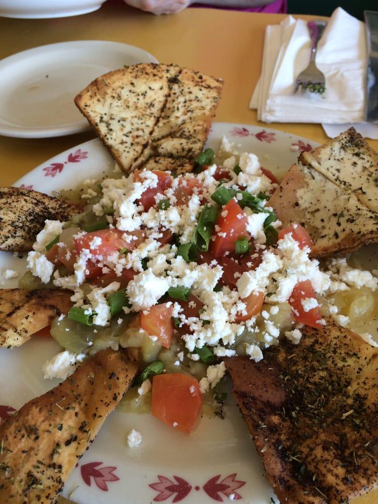 Melanzana · Charbroiled eggplant, feta cheese, tomatoes, scallions and herbs. Served with toasted pita.