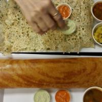 Rava Dosa · South Indian crispy crepe cooked with South Indian spices and served with sambar and chutney.