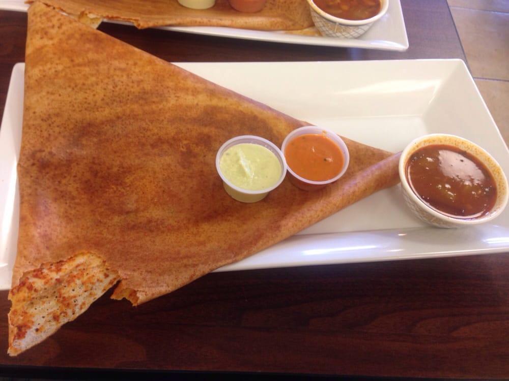 Andhra Spicy Dosa · South Indian crispy crepe spread with Andhra spicy sauce and served with sambar and chutney.