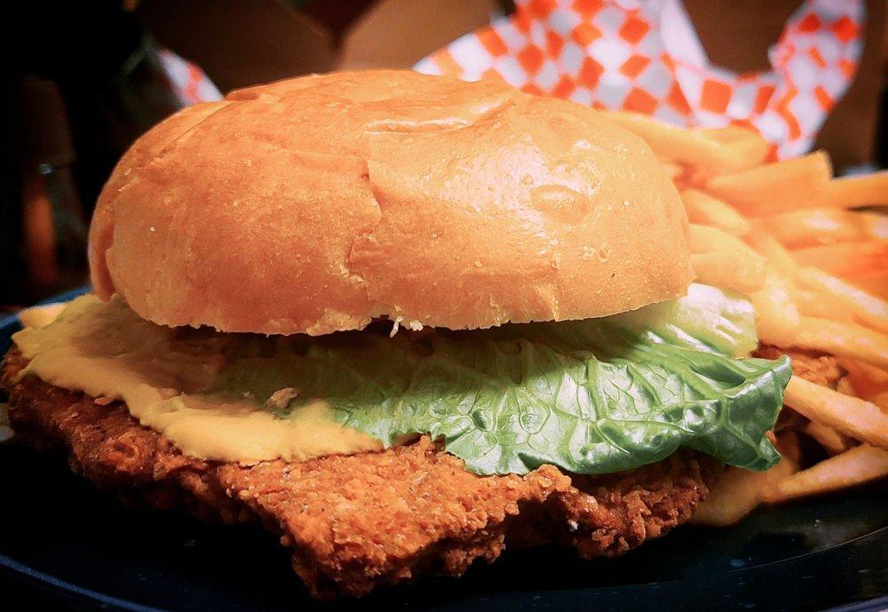 Pork Tenderloin Sandwich · Lightly breaded pork loin, lettuce, tomato, pickle, yellow mustard, fries. Served with choice of house made potato chips, coleslaw or fries.