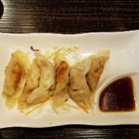 Gyoza · 6 Pieces. Pan-fried chicken and vegetable dumplings.