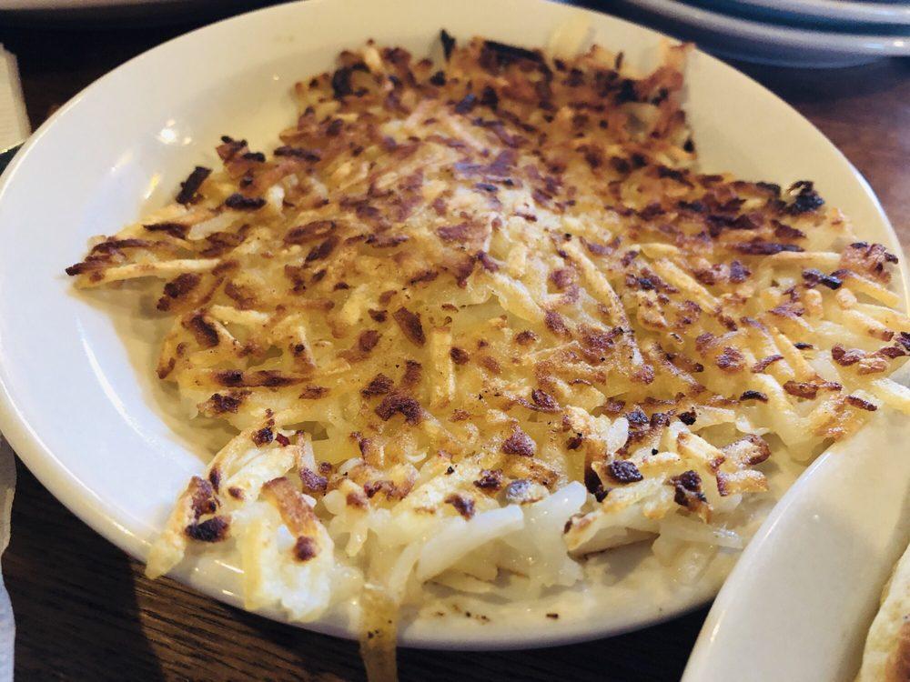 Hashbrown Casserole · Shredded potatoes, Colby cheese, chopped onions, our signature seasoning blend, salt and pepper baked together in the oven for our Signature Hashbrown Casserole.

