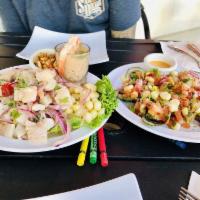 Ceviche Mixto · Seafood and fish marinated in freshly squeezed lime juice and aji. Sprinkled with herbs and ...