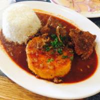 Carapulcra · Braised pork in a sauce thickened with Andean dried potatoes, panca peppers and peanuts. Ser...