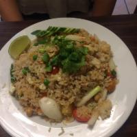 Pineapple Fried Rice · Thai style fried rice with egg, onion, tomatoes, scallion, garlic, peas, carrot, cashew nuts...