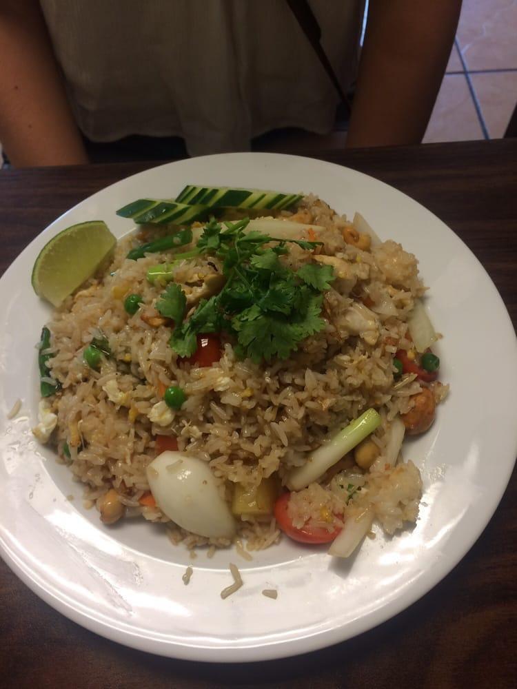 Pineapple Fried Rice · Thai style fried rice with egg, onion, tomatoes, scallion, garlic, peas, carrot, cashew nuts and pineapple.