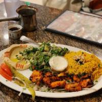 Tawook Plate · Cubes of marinated chicken with garlic. Grilled and served with rice, hummus salad and fresh...