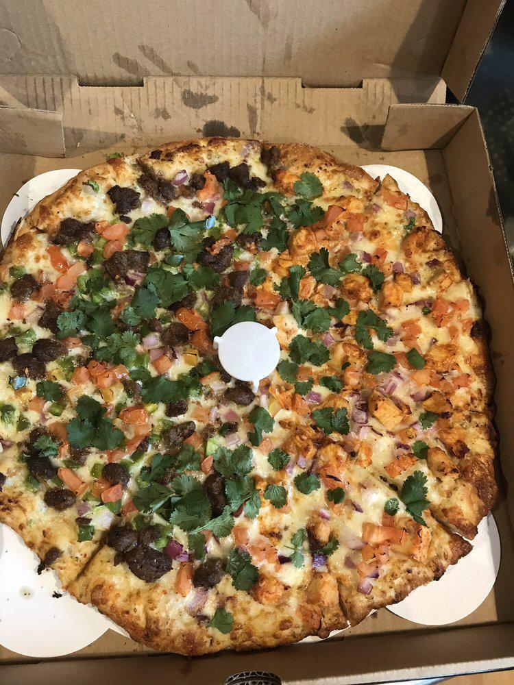 Spicy Gyro Pizza · Tender masala lamb, red onions ,bell peppers, tomatoes and fresh cilantro on a creamy garlic base. Comes with premium cheese.