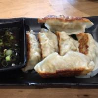 Gyoza · Pan fried pork dumplings served with our house-made dipping sauce (6 piece)