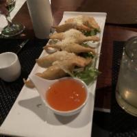 Crab Rangoon · Fresh crab meat dumplings with a cream cheese filling, served with Parmesan cheese and aioli.
