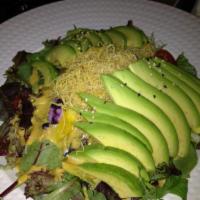 Avocado Salad · Spring mix greens topped with avocado, mango, cherry tomatoes, crispy sweet potato, blueberr...