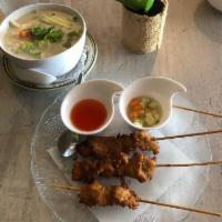 Satay Chicken · Grilled skewers marinated mock chicken. Served with peanut sauce and cucumber salad. Vegetar...
