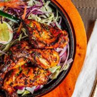 Tandoori Chicken · Legs of chicken marinated with yogurt, garlic, ginger and spices. Cooked in the clay oven.