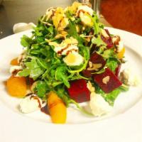 Beet Salad · Red beets with goat cheese, hazelnuts, spring mix, red onion, orange and basil vinaigrette.