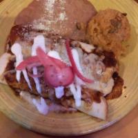 Pulled Pork Enchilada · Pulled pork with habanero orange adobo sauce, cheese, crema and red onion escabeche. 2 enchi...