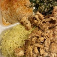 Chicken Shawarma · Thinly sliced chicken marinated in garlic sauce and grilled. Served with rice, hummus, and B...