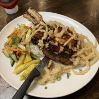 Pork Chops · Grilled pork chop topped with mushroom, onion and brown gravy. Served with mashed potatoes a...