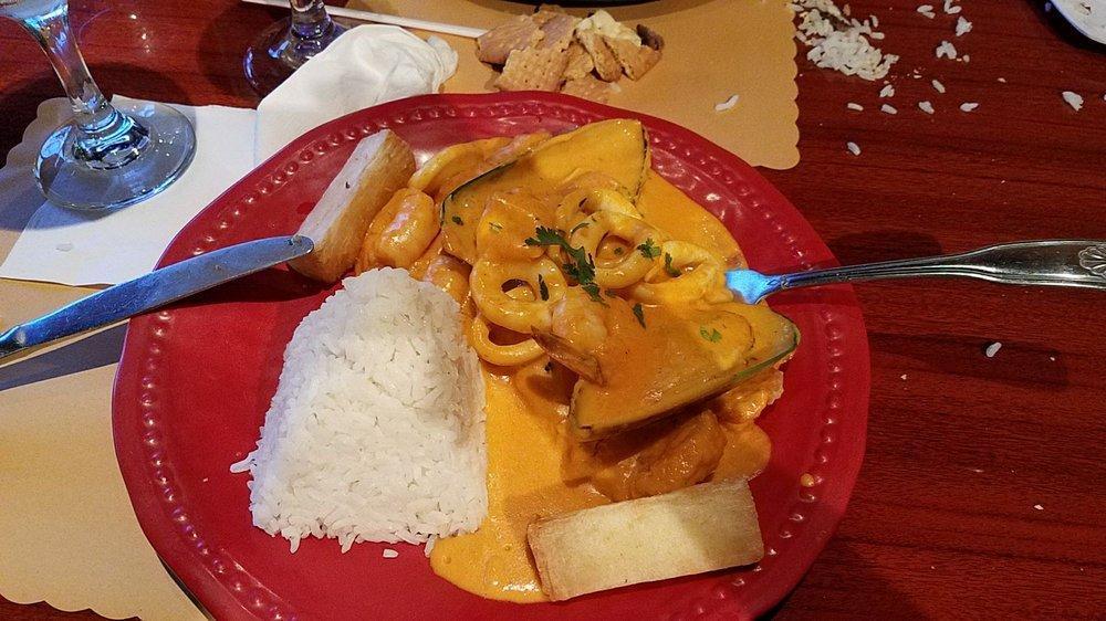 Pescado a Lo Macho · Fried fillet corvina served with a delicious seafood and lobster creamy sauce with yellow and red pepper, seafood rice and fried yucca.