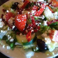 Greek Salad · Feta cheese, Roma tomatoes, sun-dried tomatoes, cucumbers, Kalamata olives and pepperoncini.