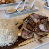 Lomo Saltado · Succulent seared steak tid bits with onions, tomatoes and french fries.