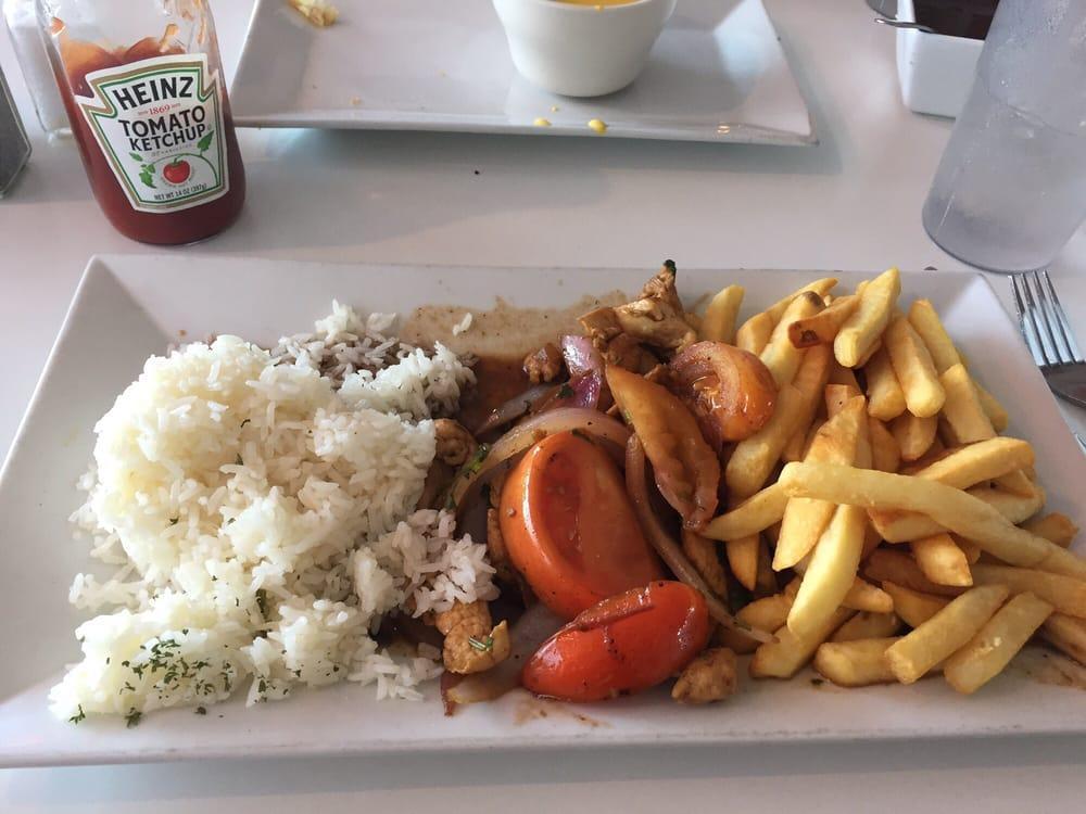 Pollo Saltado · Tender chicken tid bits seared with onions, tomatoes and french fries.
