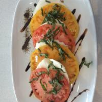 Heirloom Caprese Salad · Fresh mozzarella cheese, heirloom tomatoes, basil, salt, pepper, olive oil and balsamic.