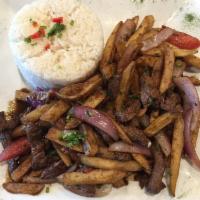 Lomo Saltado · Stir fry beef sauteed with onions, tomatoes, french fries, and white rice.