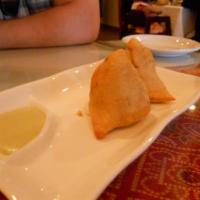 Meat Samosas · Golden fried flaky meat filled pastry.