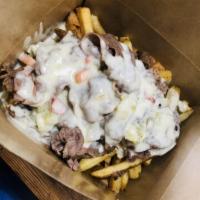 Italian Beef Frite · Chicago-style Italian beef, Asiago, giardiniera cheese sauce, and au jus, on a bed of fresh ...