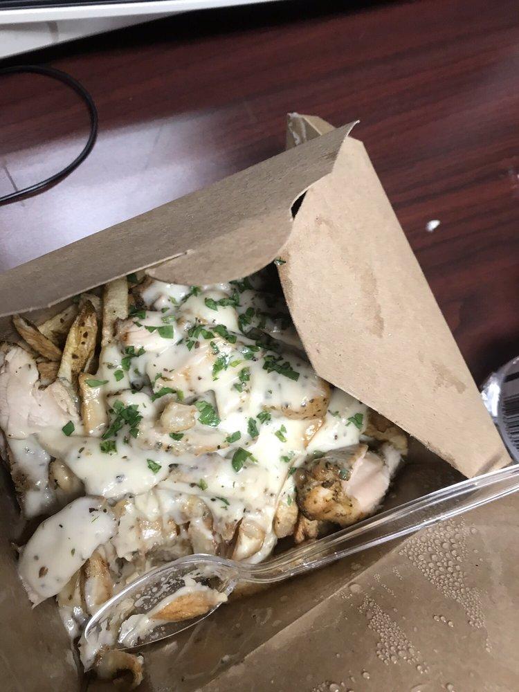 Creamy Chicken Alfredo Frite · Grilled chicken, creamy Alfredo sauce, and Parmesan cheese on a bed of fresh pomme frites.