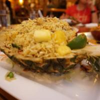 Pineapple Fried Rice · Shrimp with shredded pineapple, vegetables and basil topped with raisin and egg in fried ric...