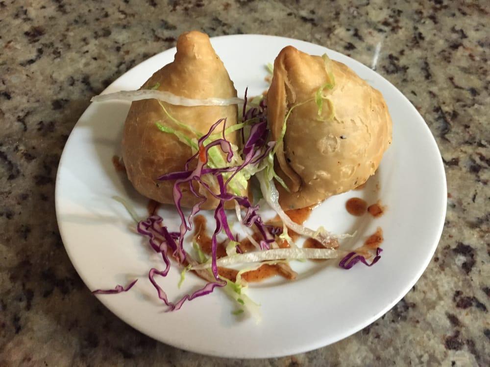 Vegetable Samosa · Mild spice potatoes and green peas wrapped in light pastry.3 pcs