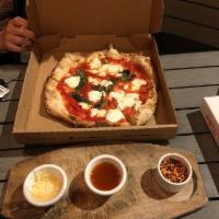 Margherita Pizza · Tomato, house-made mozzarella, basil and extra virgin olive oil.