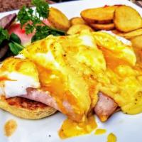 Eggs Benedict · Poached eggs with ham on a toasted English muffin with Hollandaise sauce. Served with tomato...