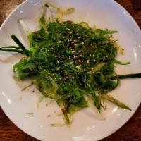 Seaweed Salad · Seaweed salad served over a bed of cucumber with chef's special sauce.