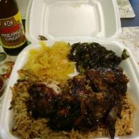 Large Jerk Chicken · Includes rice and peas or white rice and choice of 2 sides.