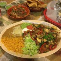 Fajitas · Meat grilled with onions, tomatoes, bell peppers, and mushrooms served with rice, refried be...
