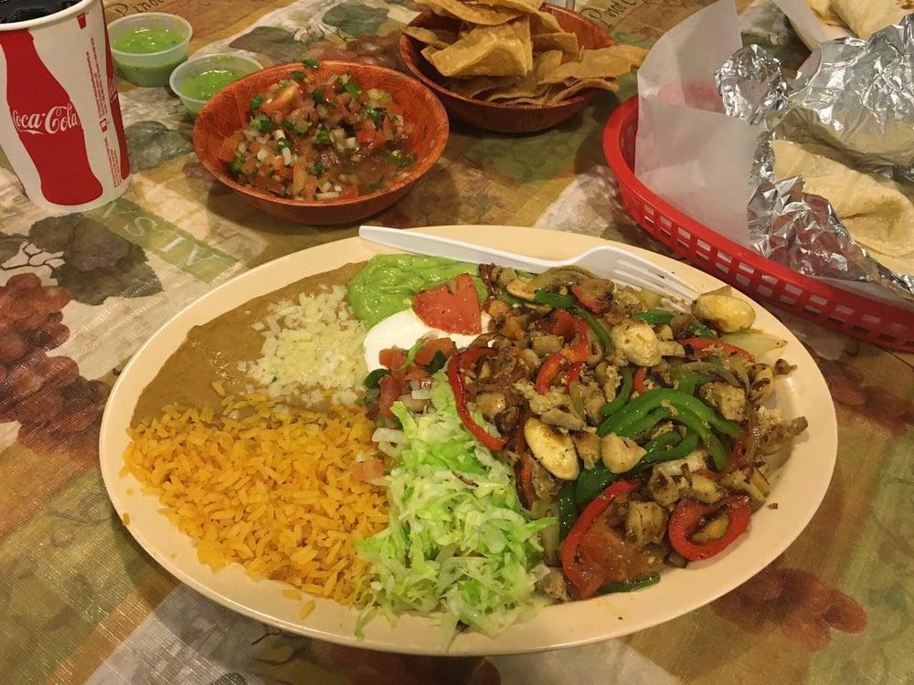 Fajitas · Meat grilled with onions, tomatoes, bell peppers, and mushrooms served with rice, refried beans topped with cheese, pico de gallo salsa, sour cream, guacamole, lettuce with option of corn or flour tortillas.