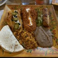 Mexican Combo · No substitutions. Beef tamale, crispy beef flauta, chicken soft taco, and veggie enchilada.