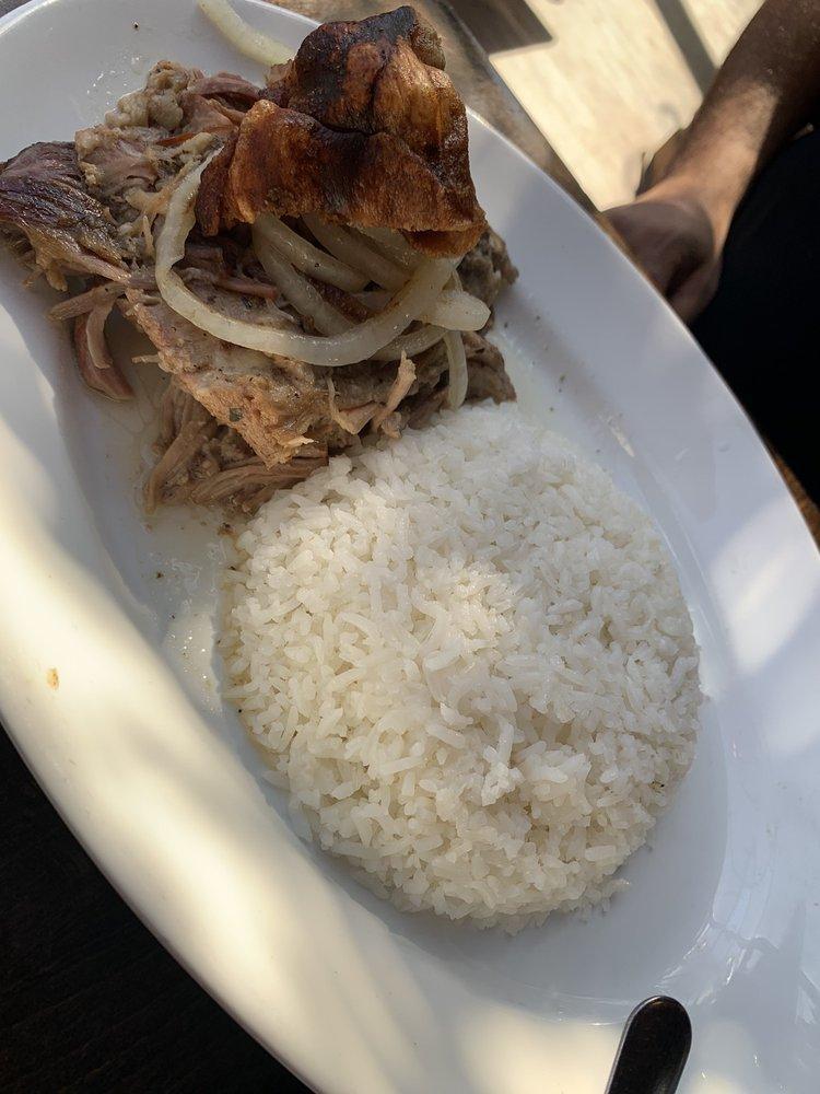 Lechon Asado · Our famous Cuban pork. Cuban style roasted pork, 24-hour marinated, topped with grilled onions and mojo.
