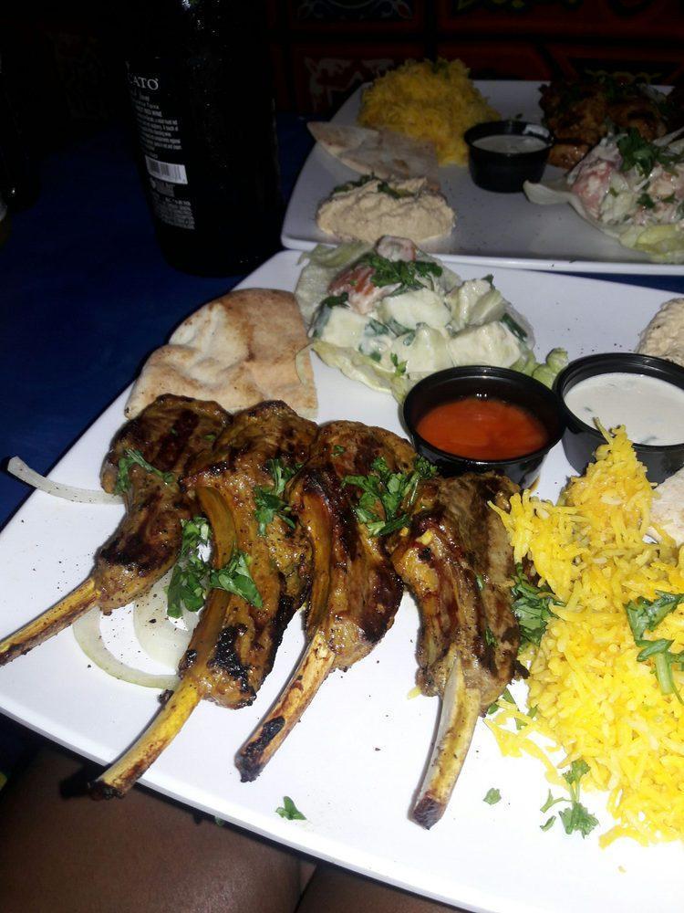 Lamb Chops · 1/2 a rack of lamb chops marinated in special seasoning. Served with saffron basmati rice and grilled tomato.