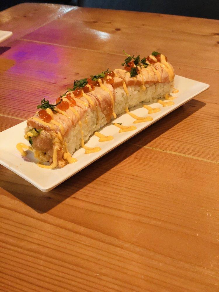Crazy Salmon Roll · Cucumber, avocado, and spicy salmon. Covered with torched salmon and ikura, topped with spicy mayo, cilantro, and eel sauce.