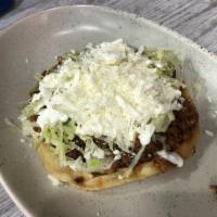 Sopes · 1 piece. Corn masa cakes topped with beans, your choice of meat, lettuce, sour cream, and ch...