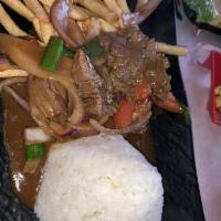 Lomo Saltado · Sautéed beef strips with onions and tomatoes served with french fries white rice