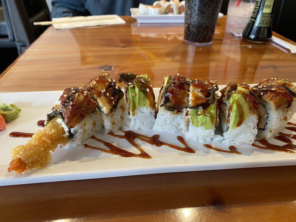 Dragon Roll · Shrimp tempura and crab topped with unagi, avocado and sesame seeds.