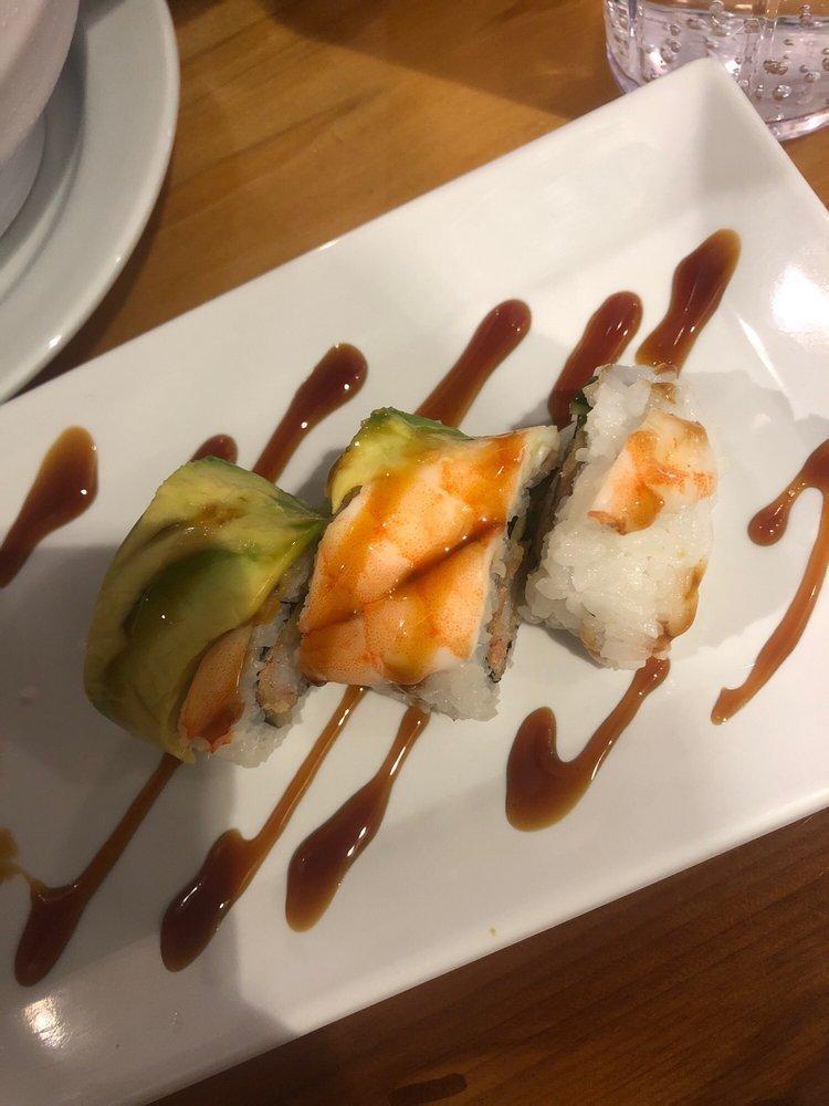 Tiger Roll · Tempura crab and cucumber topped with avocado, shrimp, and unagi sauce.