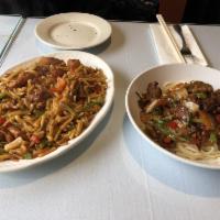 Goyro Laghman · On-the-spot, hand-pulled noodles topped with stir-fried lamb and various combinations of veg...