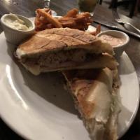 Cuban Sandwich · Traditional Cuban pressed sandwich with roasted pork, ham, Swiss cheese, pickles, mustard an...