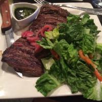 Churrasco · Cuban-style skirt steak marinated in salsa borracha with chimichurri and cebollitas. Served ...